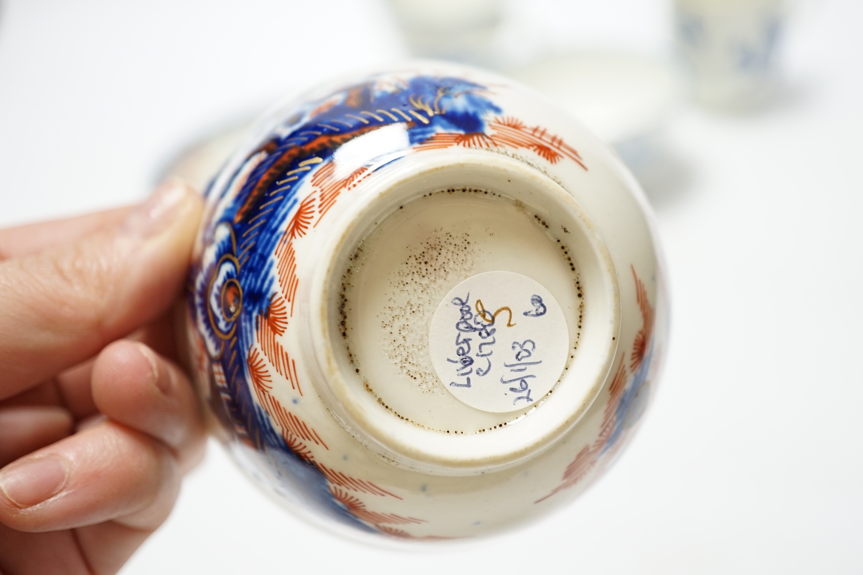 A Worcester James Giles decorated coffee cup, c.1765-70, a Caughley reeded tea bowl, a Pennington tea bowl and saucer and a coffee cup, tallest cup 6.5cm (4)